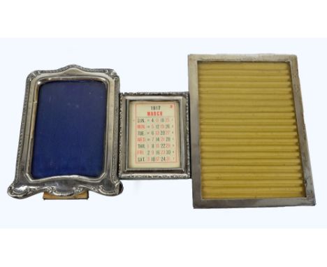 Three George V hallmarked silver fronted rectangular photograph frames, including foliate scroll and bead decorated example b