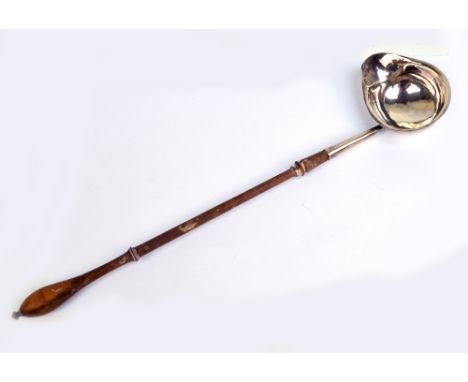 A George III hallmarked silver toddy ladle with oval bowl and lip to one side, with turned wooden handle, maker's mark obscur