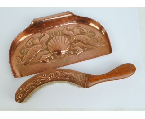 An Arts and Crafts style Newlyn hammered copper crumb brush and tray, both with embossed marine decoration, the tray with pre