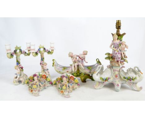 A group of decorative ceramics including a lamp base, height including fitting 42cm, a pair of candlesticks and wall sconces,
