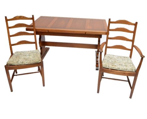 An Ercol draw leaf refectory type dining table and six ladder back chairs with padded seats and turned front legs, length of 