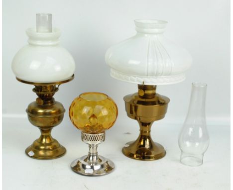 A brass oil lamp with circular base, brass reservoir, opaque white shade and chimney, the wick adjuster inscribed 'Duplex Mad