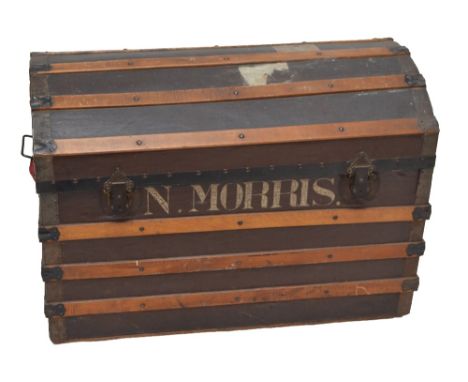 A dome top twin handled steamer/travelling trunk with previous owner's name inscribed to front 'N.Morris.', height 65cm, widt