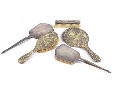 An early 20th century American sterling silver backed dressing table hand mirror, length 33.5cm, and a matching hand brush, s