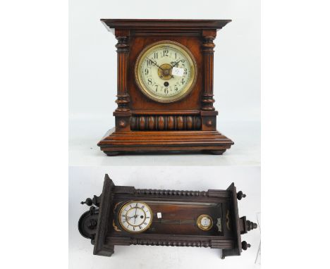 A 19th century Vienna eight day wall clock with shaped mask decorated pediment, the circular dial set with Roman numerals, an