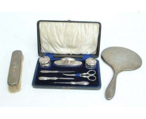 JONES & CROMPTON; a cased George V hallmarked silver mounted manicure set, Birmingham 1916, and an engine turned decorated ov