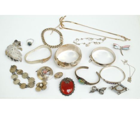 A group of silver jewellery including two snap bangles, a Scottish thistle decorated brooch, a leaf shaped example (pin af), 