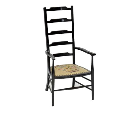A late 19th/early 20th century ebonised ladder back chair with canvas upholstery on turned front supports and stretcher, heig