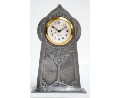 LIBERTY & CO; an English pewter timepiece, the shaped case with stylised Art Nouveau decoration now housing a replacement mod