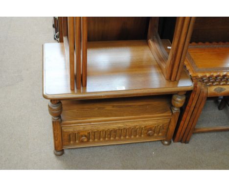 An Ercol side cabinet with rear hinged flap above open section and drawer beneath, width 74cm.