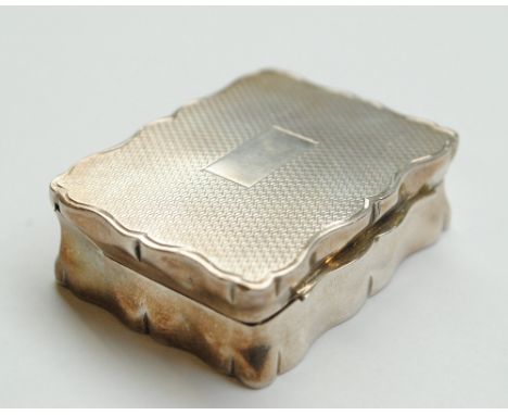 JOHN ROSE; a George VI hallmarked silver snuff box of shaped rectangular form with engine turned hinged lid and vacant rectan