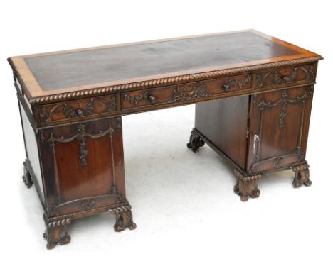 A good early 20th century mahogany Chippendale style twin pedestal desk, the crossbanded top with gadrooned border, leaf and 