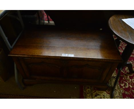 An oak storage unit modelled as a coffer with panelled fall-front, on bracket feet, 81 x 43cm, height 44.5cm.