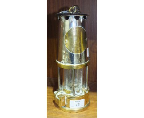 An early-20th century Protector Lamp and Lighting Company brass and metal miner's lamp, 25cm high.