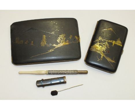 A Japanese black-lacquered metal cigarette case decorated with landscape and figure, 8 x 12cm, a similar smaller case, 9 x 5.
