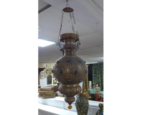 A Moroccan Mamounia copper ceiling pendant light, with pierced scroling decoration and coloured glass apertures, H.104cm 