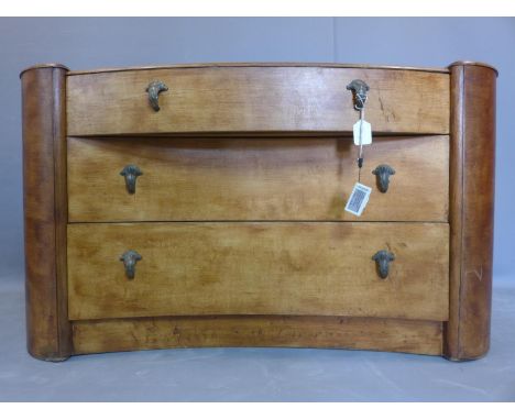 An Art Deco walnut chest of three drawers, having one bow fronted drawer above two concave drawers, raised on pedestal base, 