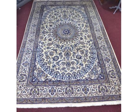 A large part silk Persian Nain Isfahan carpet, central medallion and stylised floral motifs on a cream ground, within stylise