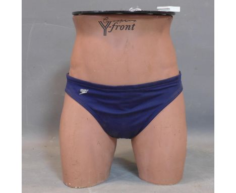 An unusual lamp table made from a half mannequin wearing speedos, marked Coopers Y Front, H.38cm 