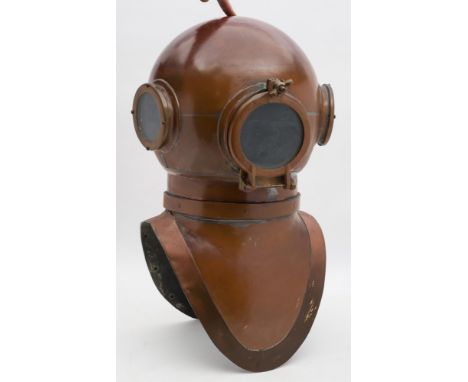 An un-named copper and brass diving helmet:, constructed in three sections with circular side and front windows, stamped 'X39