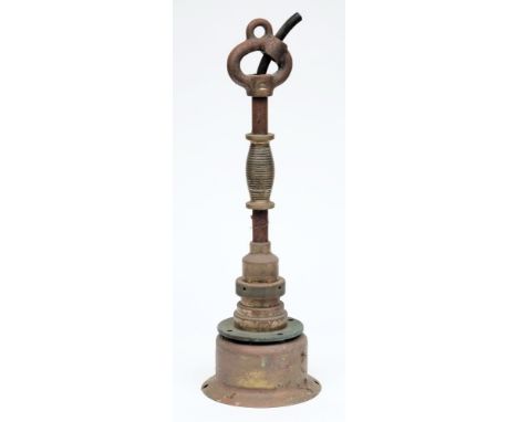 An early 20th century diving lamp:,  the shade secured by a brass ring to a two section shaft with waisted reeded handle and 