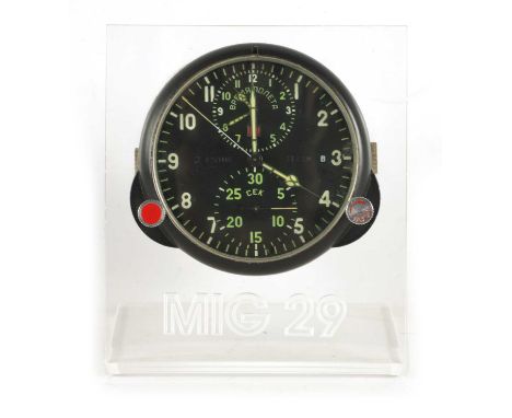 AN ORIGINAL RUSSIAN MIG 29 AIRCRAFT CHRONOGRAPH COCKPIT CLOCK having a black dial with Arabic numerals fronting a mechanical 