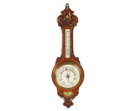 A LATE 19TH CENTURY OAK ANEROID WHEEL BAROMETER with leaf carved case enclosing enamel calibrated dials89cm high 
