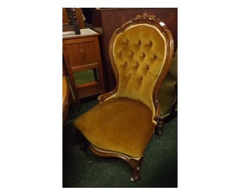 Victorian walnut framed nursing chair in a yellow Dralon upholstery with button back, cabriole front legs and carved foliage 