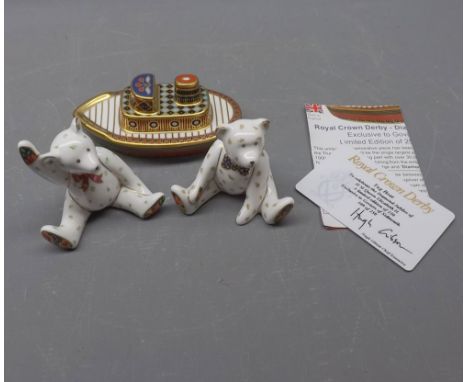 Two small Royal Crown Derby models of seated teddy bears, one with his arm raised in the air, together with a further Royal C