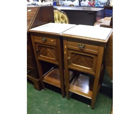 Pair of French pine marble top bedside cupboards, fitted with single drawer over panelled cupboard door and open shelf, raise