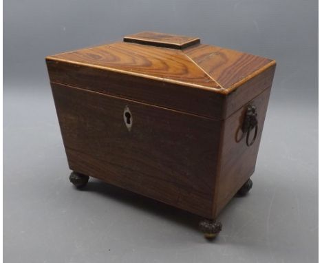 Late Regency rosewood veneered tea caddy of tapering rectangular form with sloped hinged lid on four cast ball feet, fitted i