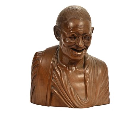 A 20th century hardwood head and shoulders sculpture of Mahatma Ghandi, signed to base Dew Pasar.. Bali. Nadepanti. W.  26 cm