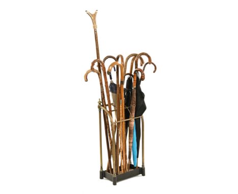A late 19th/early 20th century brass stick stand with drip tray, complete with a collection of walking sticks, thumb stick an
