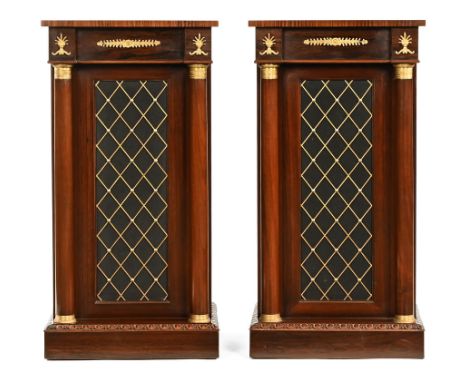 A pair of Regency style rosewood pedestal cupboards, with rear doors, being brass strung and with inverted breakfronts and gr