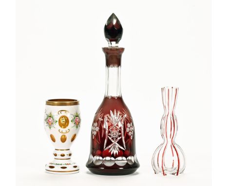 An Edwardian ruby and faceted glass decanter, a milk glass overlay goblet and a ribbed specimen vase.  Tallest 38 cm.