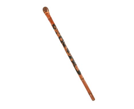 A Japanese bamboo walking stick, carved in relief with skeletons.  88 cm long. (see illustration).