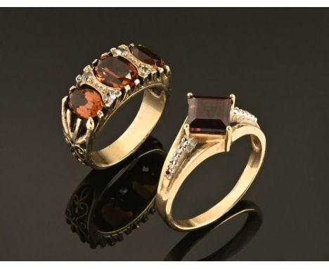 A 9 ct gold dress ring with ruby coloured stone, Size T/U and another gold coloured metal dress ring Size M/N.