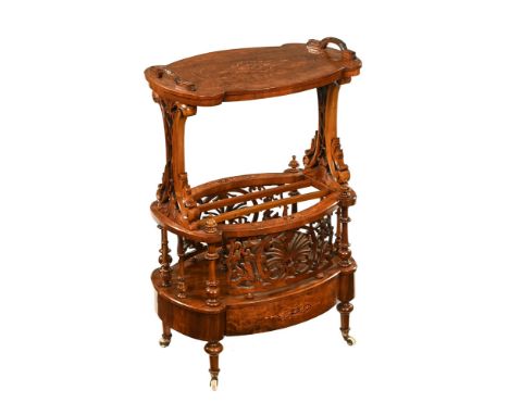 A Victorian inlaid walnut Canterbury, with fretwork front and raised on turned legs terminating in brass and ceramic castors.