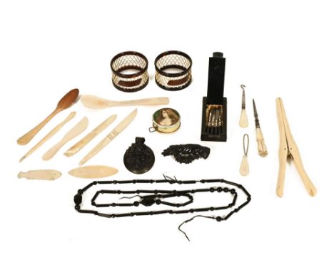 A quantity of bijouterie to include mother of pearl cutlery, a pair of tortoiseshell latticework napkin rings a circular ivor