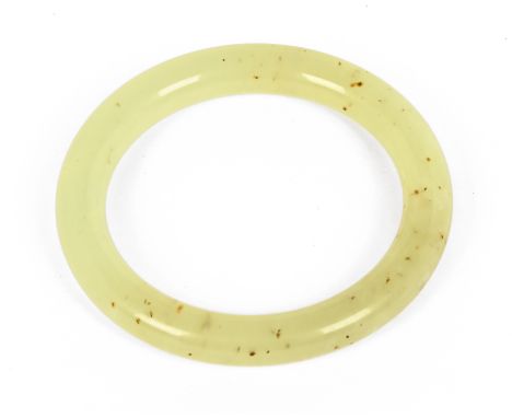A Chinese jade bangle, internal diameter 63 mm.