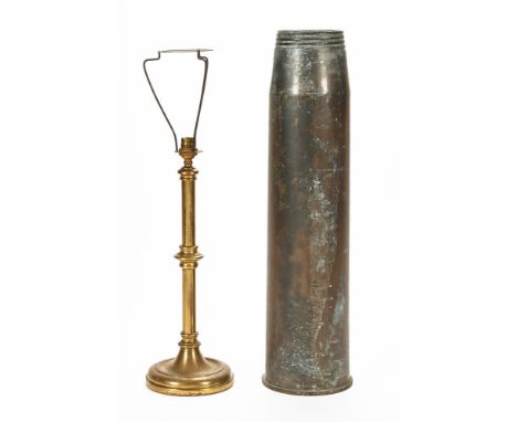 A large brass shell case and a brass table lamp.  Tallest 63 cm.
