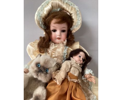 Antique C M Bergman Walterhausen Germany, 1916 child doll on original body and later clothes together with her own Heubach 25