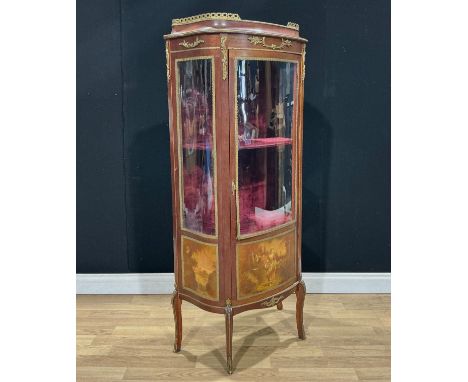 A Louis XV style gilt metal mounted mahogany vitrine or display cabinet, three-quarter glazed door, the lower panel decorated