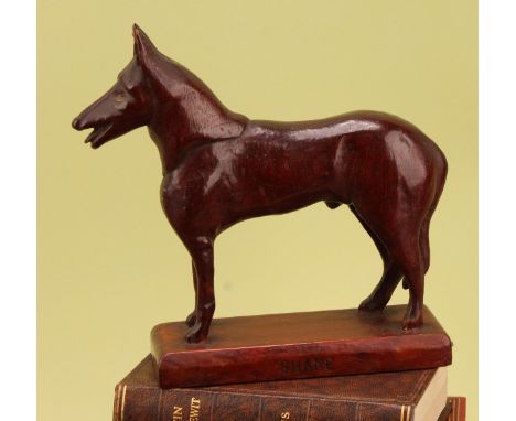 Folk Art - an early 20th century mahogany carving of an Alsatian dog, Shane, rectangular base, 21cm high