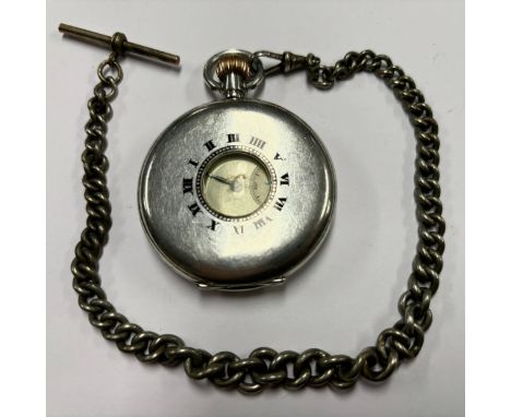 A silver cased Art Deco half hunter pocket watch on Albert chain, white enamel dial, bold Roman numerals, minute track, the c