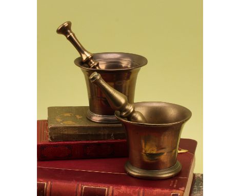 An 18th century bronze bell shaped pestle and mortar, 10cm high, c.1760; another (2)