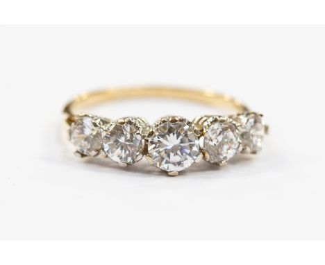 A five stone Cubic Zirconia dress ring, graduated round cut CZ stones, 9ct gold, size N, total gross weight approx 2gms 
