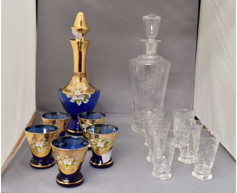 Two liquor set, blue and gold glass decanter, five glasses, plain glass decanter and six glasses