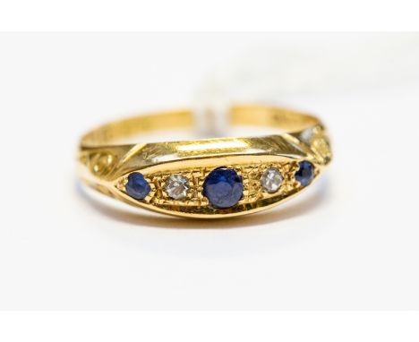 A Victorian sapphire and diamond boat head ring, set with three sapphires with diamond accents, 18ct gold,  size L, total gro