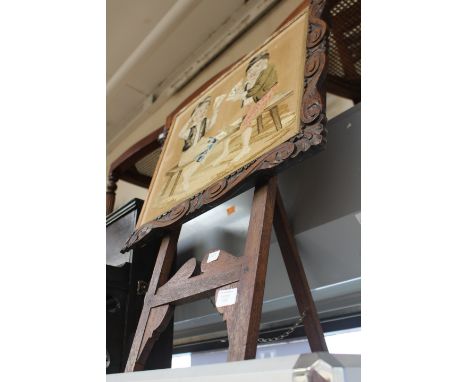 A 19th Century woolwork, boys playing cards, carved mahogany frame on easel 